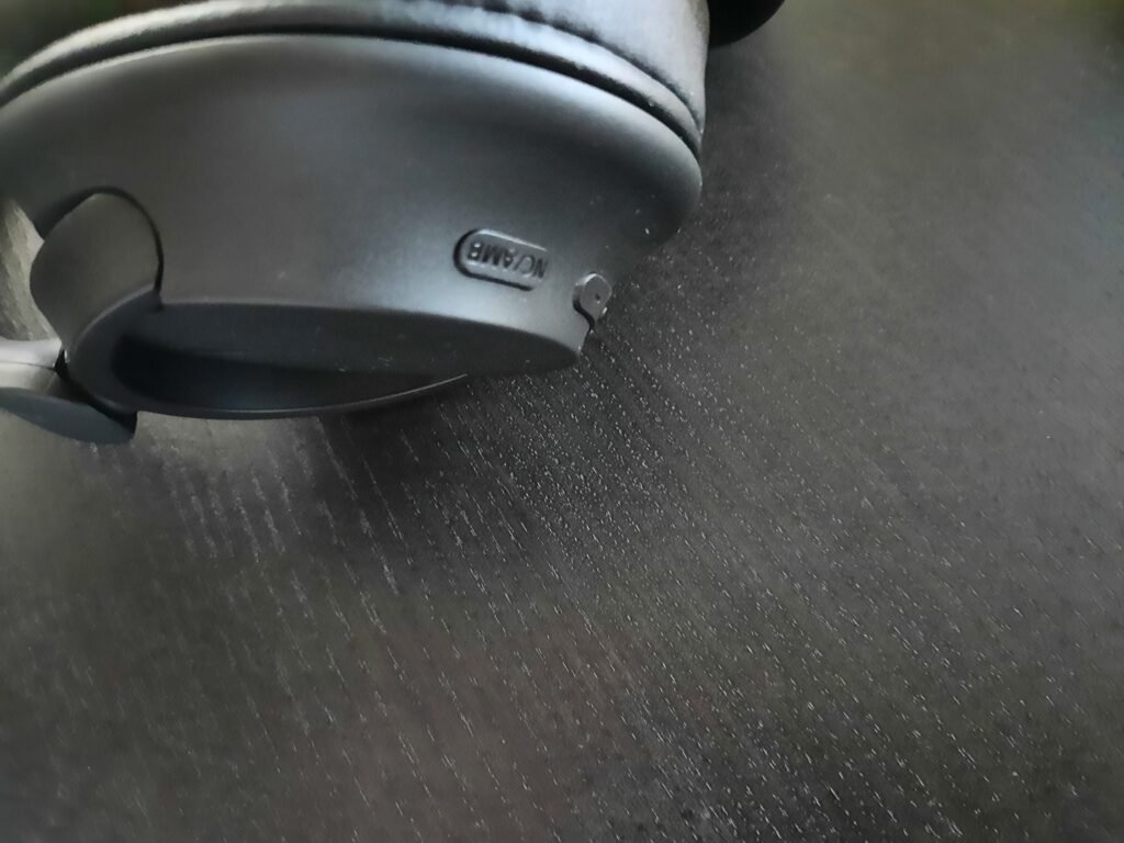 In this image, the noise-canceling button. Near the volume buttons of the Sony WH-CH720N noise-canceling wireless headphones.